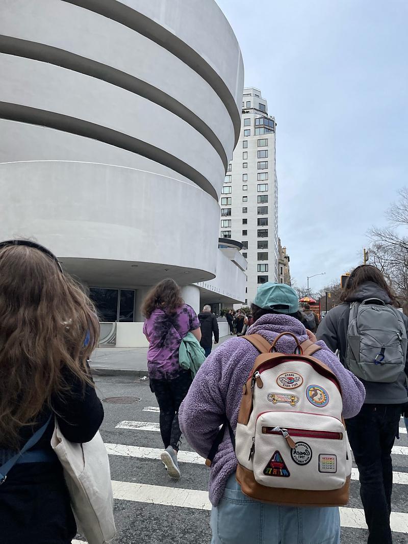 Group of students outside walking toward Guggenheim