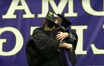 即将毕业的学生Eric Ellman拥抱他的父亲Mark Ellman, 谁是地标学院的受托人, 在毕业典礼上.